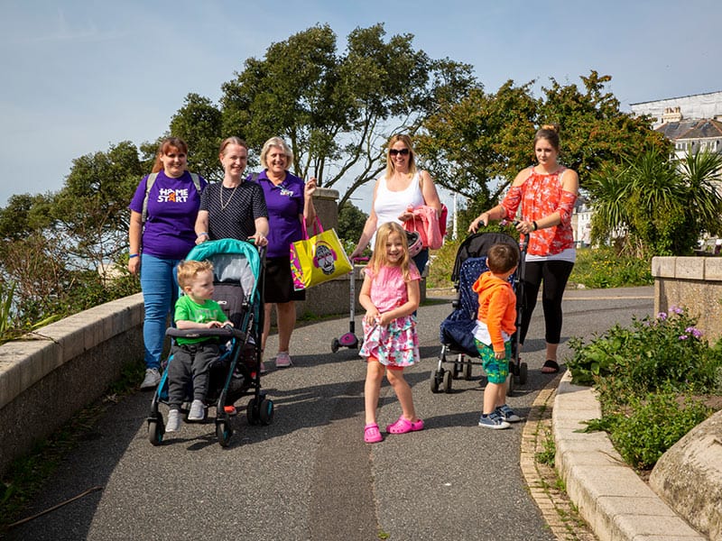 Family and Home-Start volunteers walking with parents